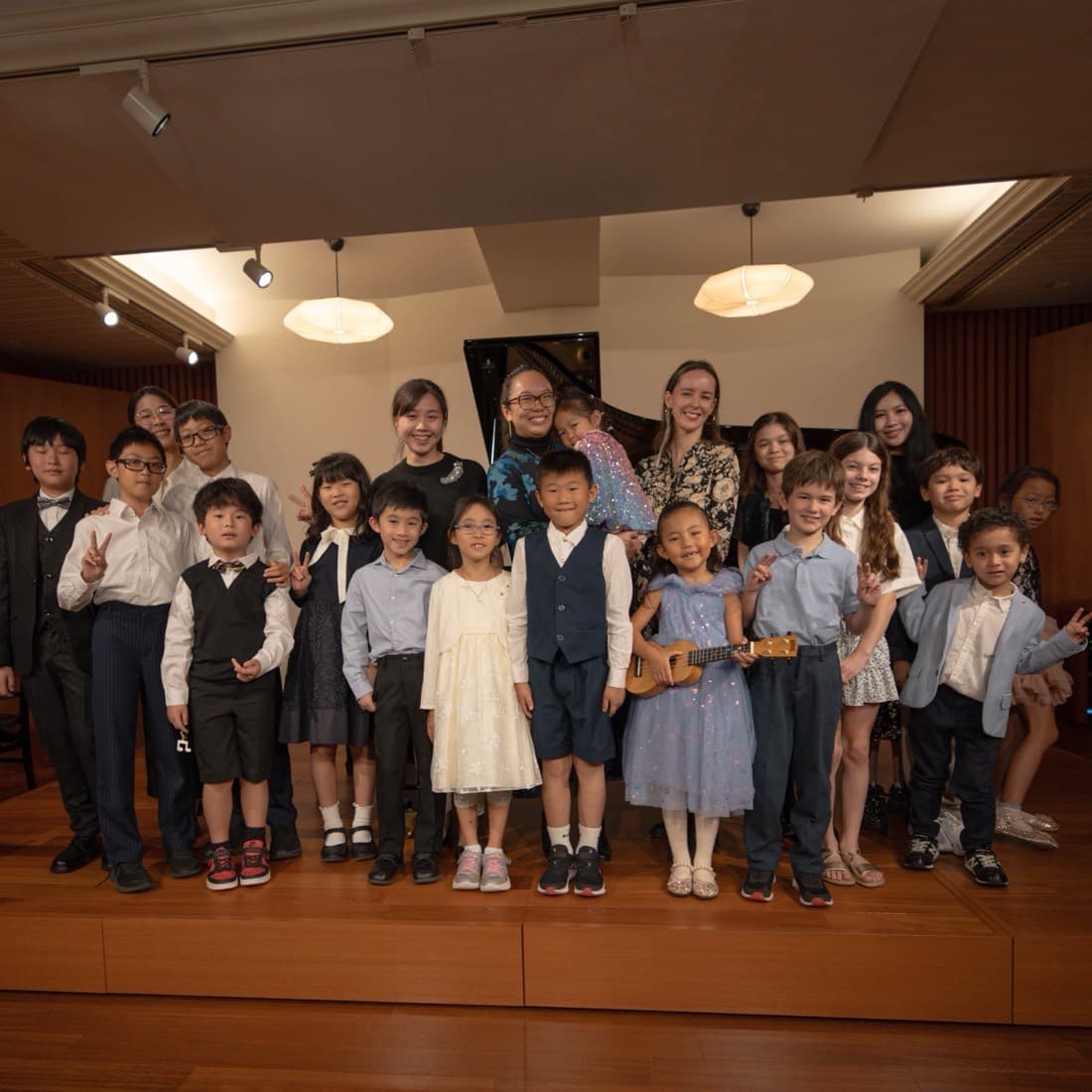 Kathrine Leong and the young performers on stage after the Minim Family recital