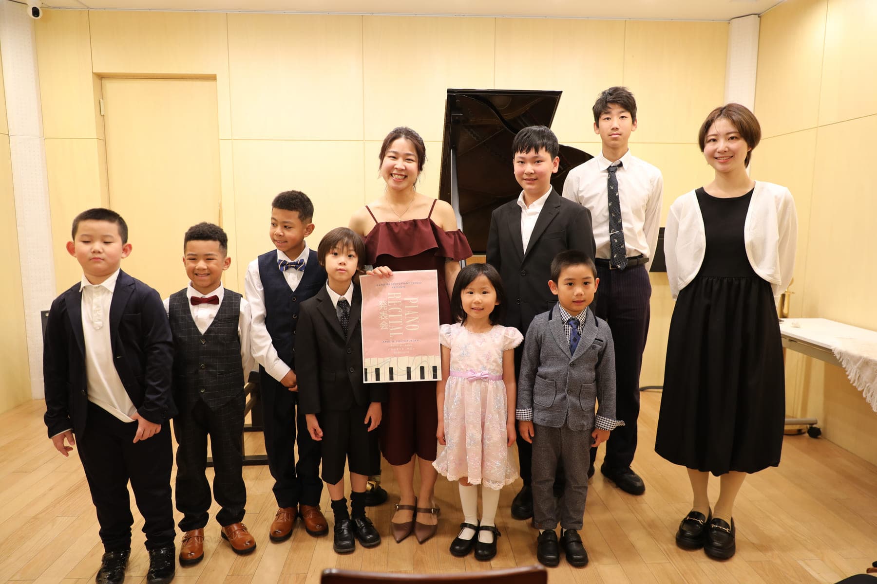Kathrine Leong and her students on stage after a recital